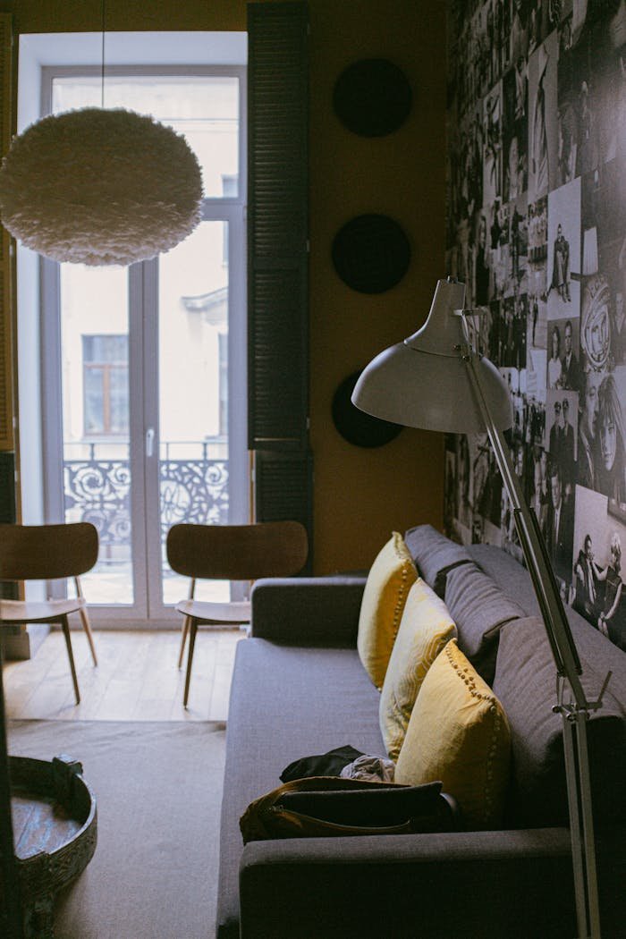 Warm living room featuring modern design with sofa, lamp, and decorative elements.